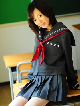 Sweet Asian schoolgirl takes a break in the classroom