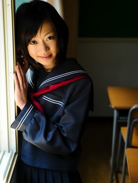 Sweet Asian schoolgirl takes a break in the classroom