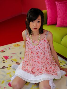 Skinny Japanese babe poses in her cute pink dress