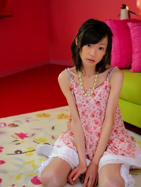 Skinny Japanese babe poses in her cute pink dress