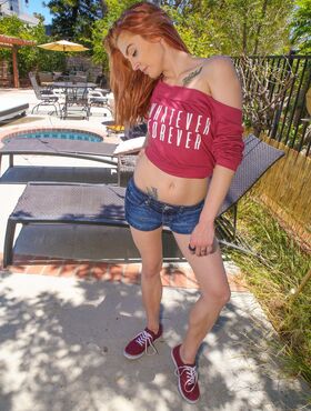 Cute redhead teen Kandi Quinn is sunbathing her sexy petite body by the pool