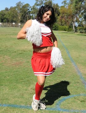 Dark haired cheerleader Christina Moure strips from her uniform