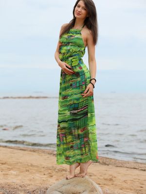 Stunning 18 - Slender teen Ganna A drops her long dress to air perfect tits on the beach